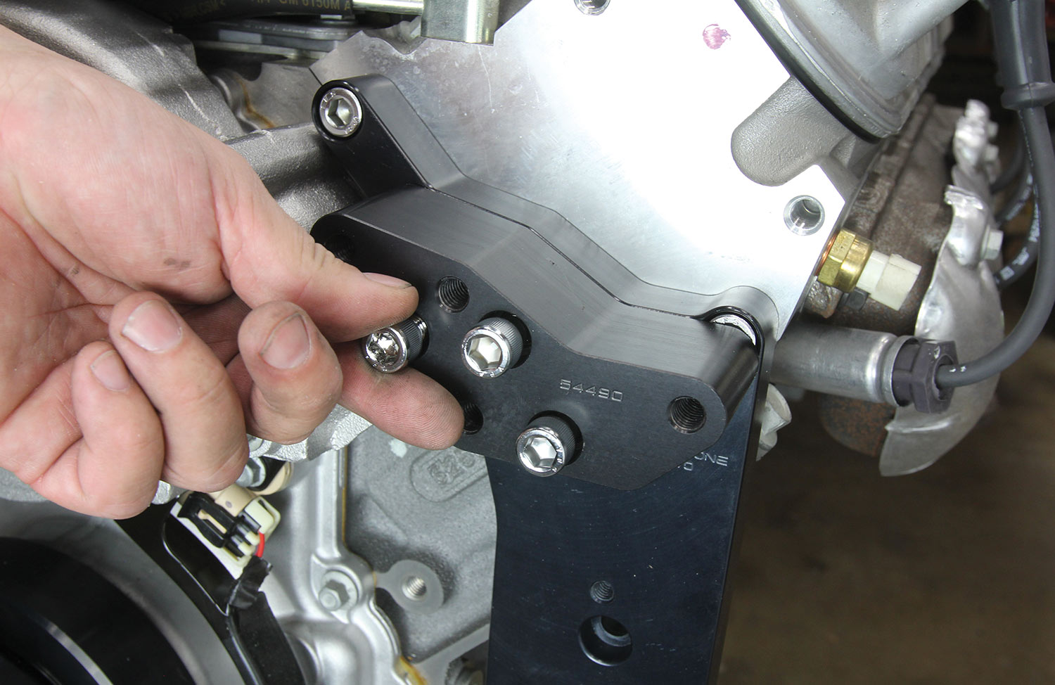 the alternator spacer bracket attaches to the main bracket using three 3/8x2-inch fasteners