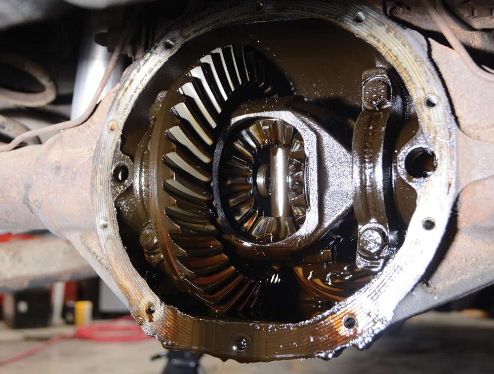Differential with cover removed showing oil soaked gearing