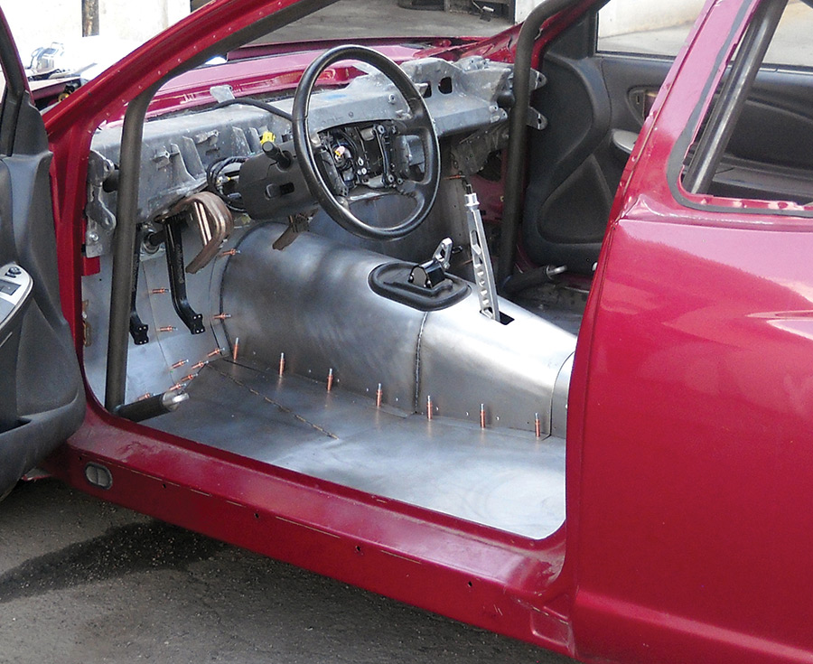 Paul’s Automotive is handling all the fabrication work, including laying a new floor and trans tunnel in the cabin. Note the drifting-spec brake handle, too. This car is being built to drop some jaws.