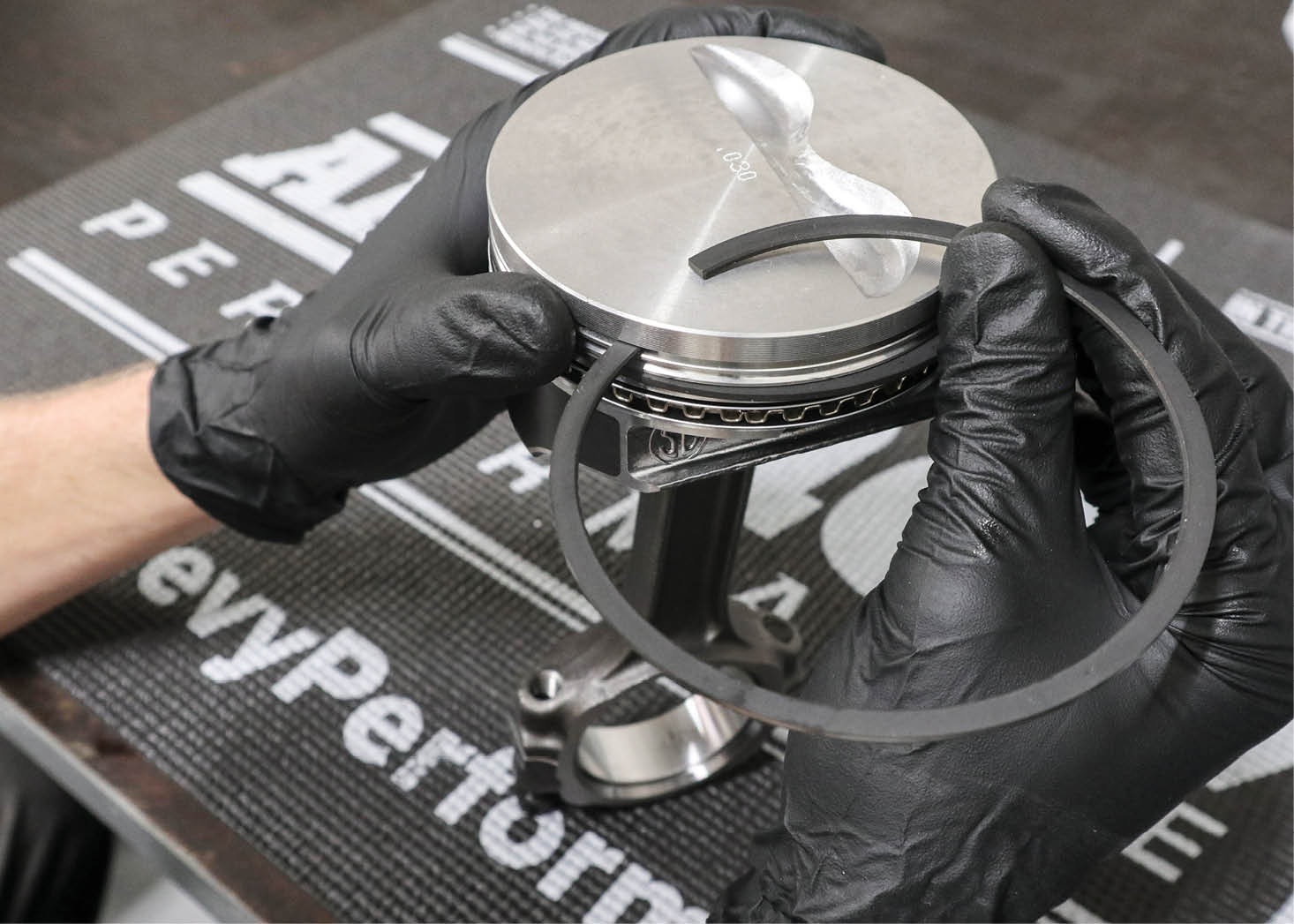 We installed the rings on the pistons, making sure to offset each ring endgap for proper sealing.