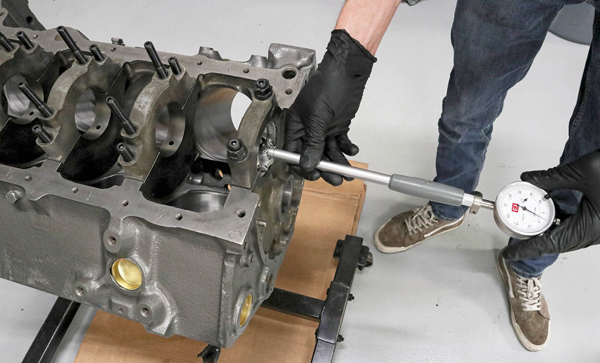 We used a micrometer to measure the crankshaft journal diameter and, after torquing the first main cap to spec, a dial bore gauge to measure the bearing clearance.