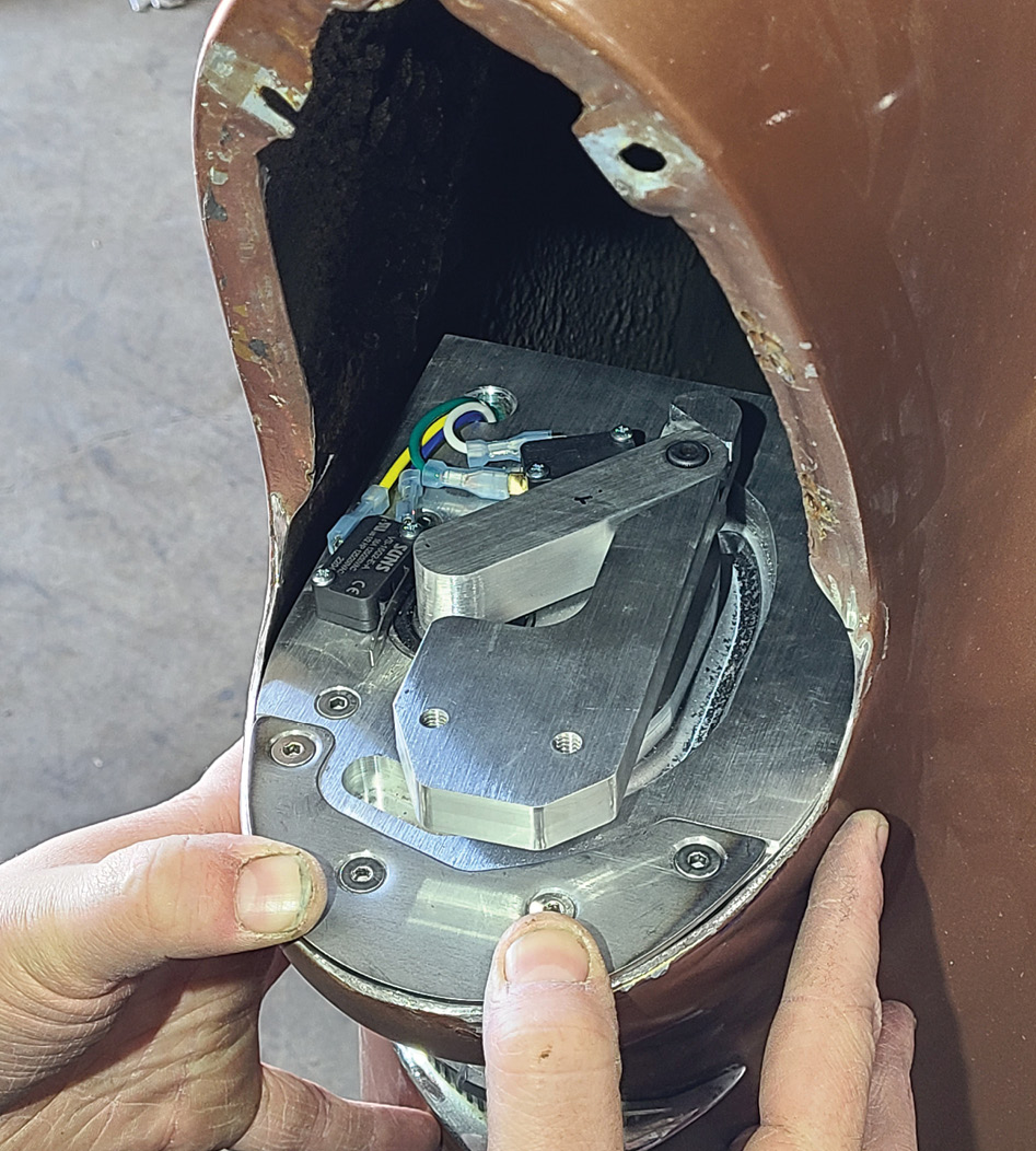 With the horseshoe bracket screwed in place to the motorized base, the unit is fit into place and pulled rearward for a flush fit to the opening. (As you install and remove the unit multiple times during this part of the build, you’ll need to support it in the opening somehow—OCHR used small magnets to keep it from falling inward.) 