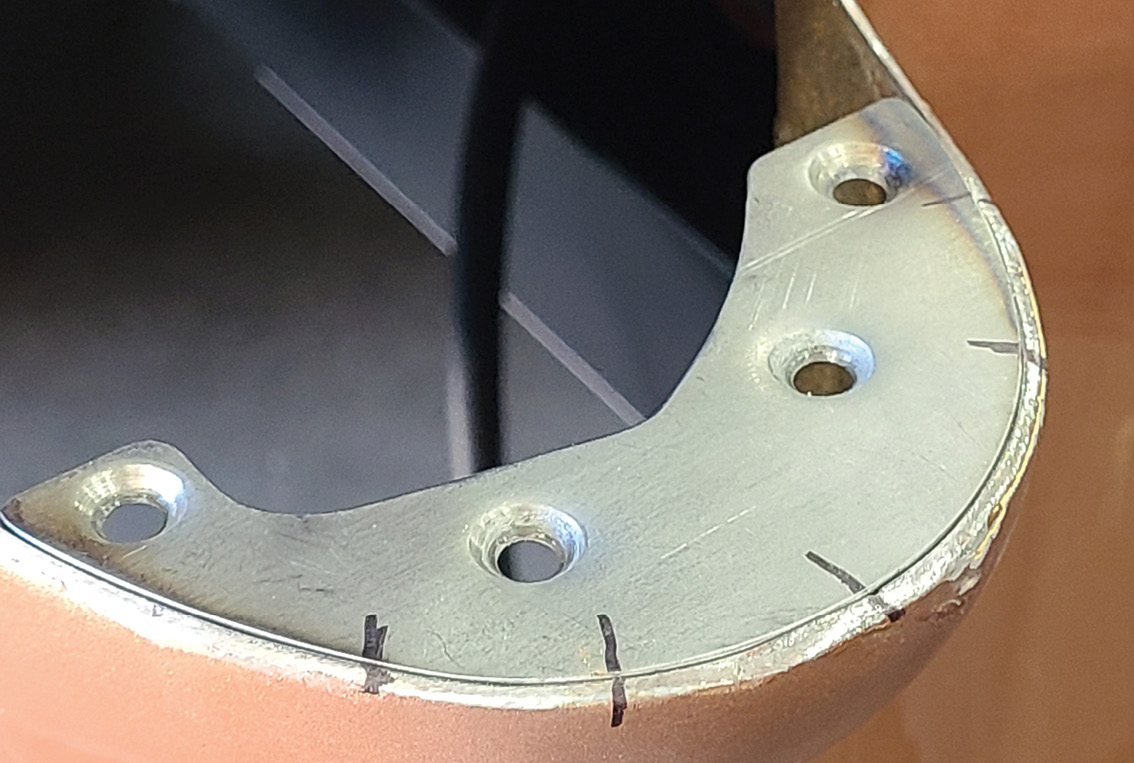 Using magnets underneath to hold it in place, the horseshoe bracket is set in place.