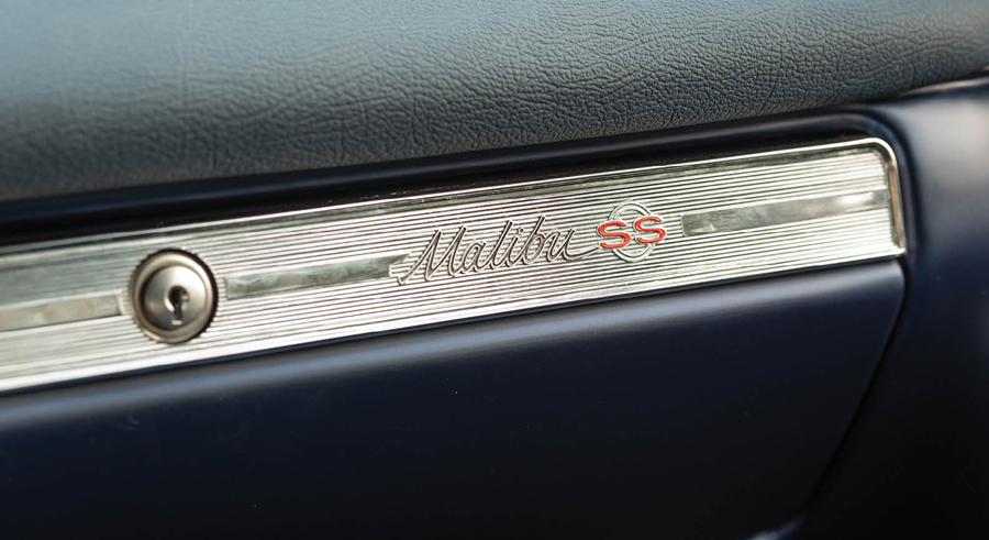 close up of a closed glove compartment with a Malibu SS emblem label