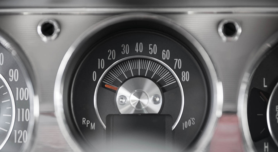 close up of a black speedometer with chrome dash