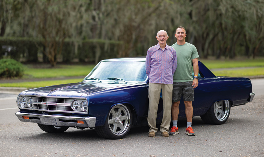 Sidney Dyson and his son, Sam, standing in front of a blue ’65 Chevrolet Chevelle Malibu SS