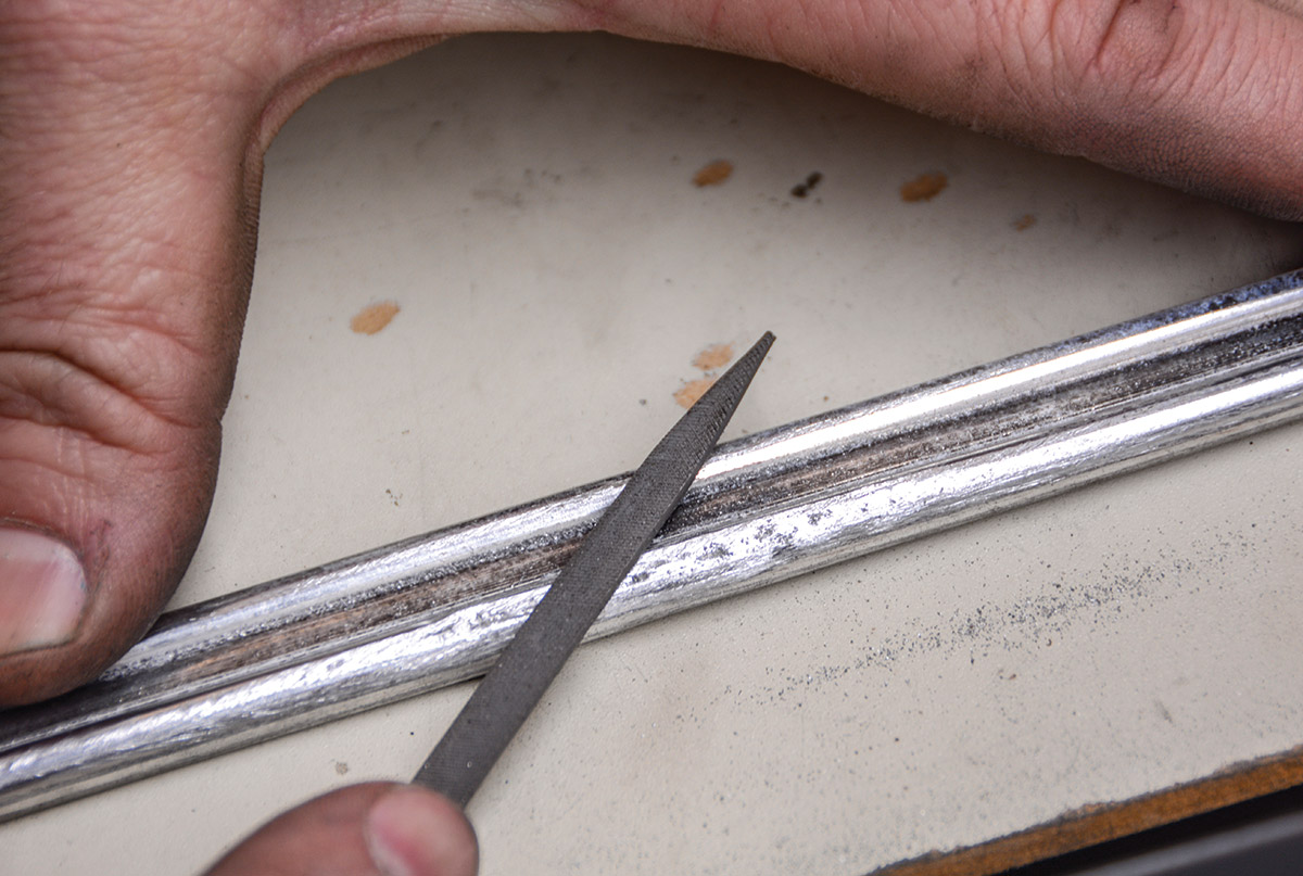 Filing is crucial, as even the best metal workers can struggle to completely straighten such thin aluminum. The files in the trim repair kit work perfectly for showing you the low spots in your hammer and dolly work. Some of the minor low spots can be filed out smooth. If you see extreme low spots, you’ll need to do more hammering before moving onto the next step.