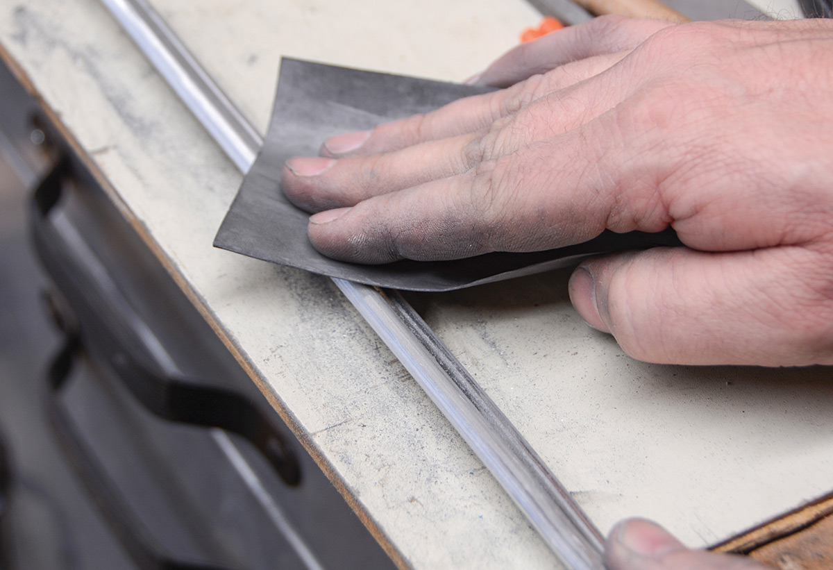 As we move into the finer grits, most of the sandpaper can be used in wet or dry conditions. No matter how you go about it, this is a messy job, as the aluminum dust is black.