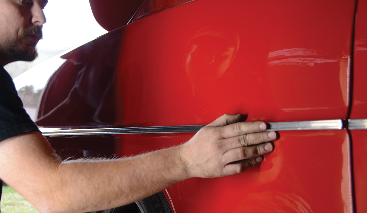 The quarter-panels have nine plastic push-in clips per side and one spring clip with a stud on each side. We fed the plastic clips into the trim channel and then carefully pressed the clips into place, working our way toward the back of the car as we went. You’ll need 28 plastic push-in clips for a full install.