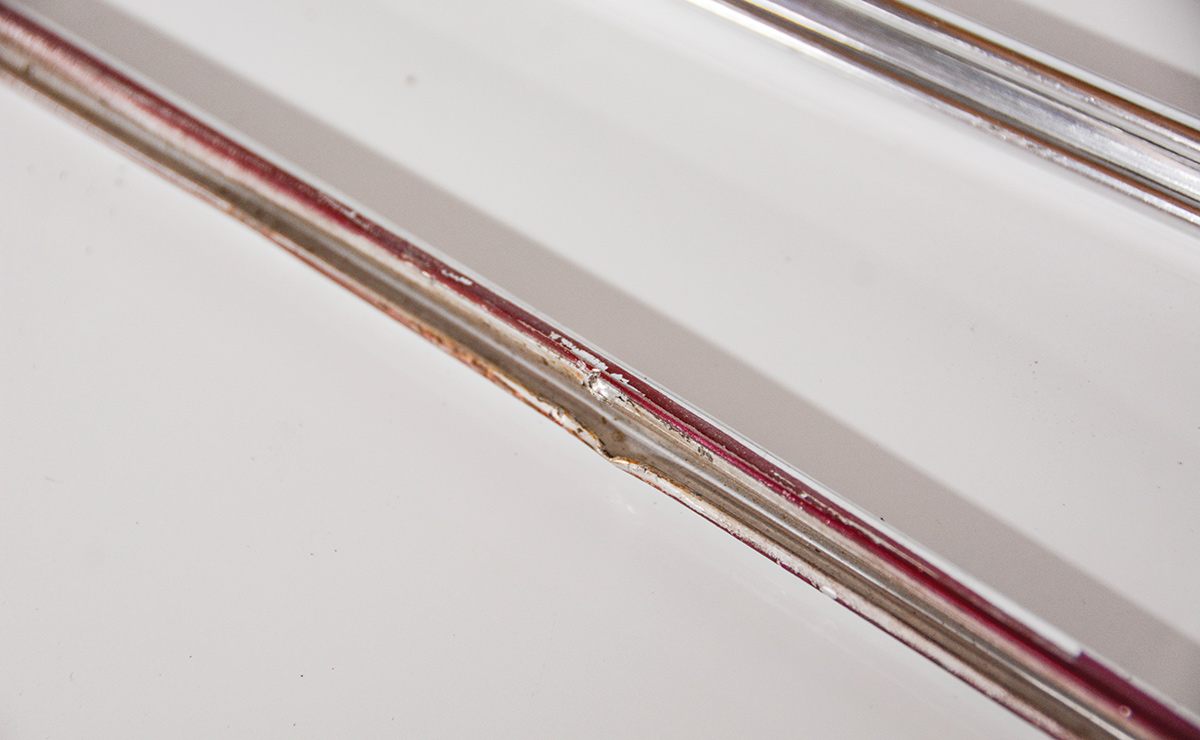Our ’66 Chevy II received a cheap paintjob at some point in the ’90s. As you can see, the aluminum trim was not removed and the masking left a lot to be desired. You may also notice some damage where someone tried to remove the trim without removing the clips from the body.