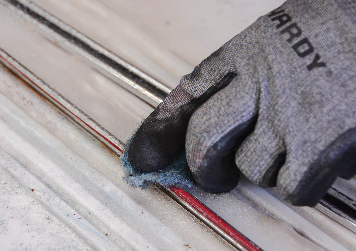 Soap pads are a nice abrasive to remove the paint and anodized coating from the trim without scratching. Be sure to wear gloves, as the oven cleaner can be rough on your skin.