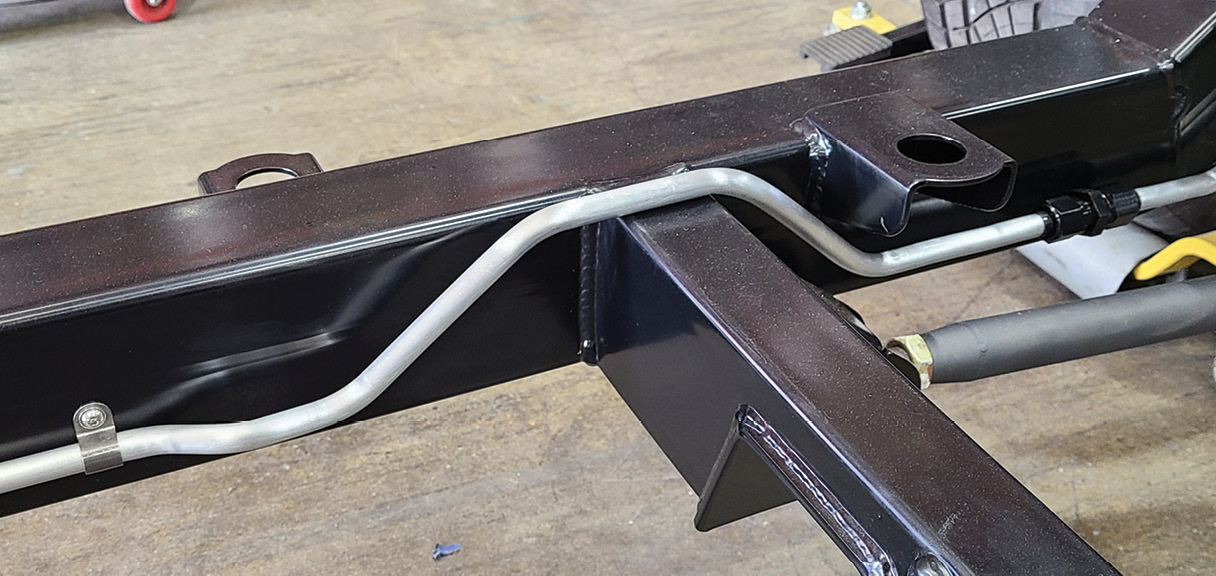 The large 1/2-inch fuel lines for the Holley injection system will neatly fit under the body when mounted. Where ³/8-inch would normally be used in this instance, 1/2-inch line was installed because future plans include the addition of a supercharger.