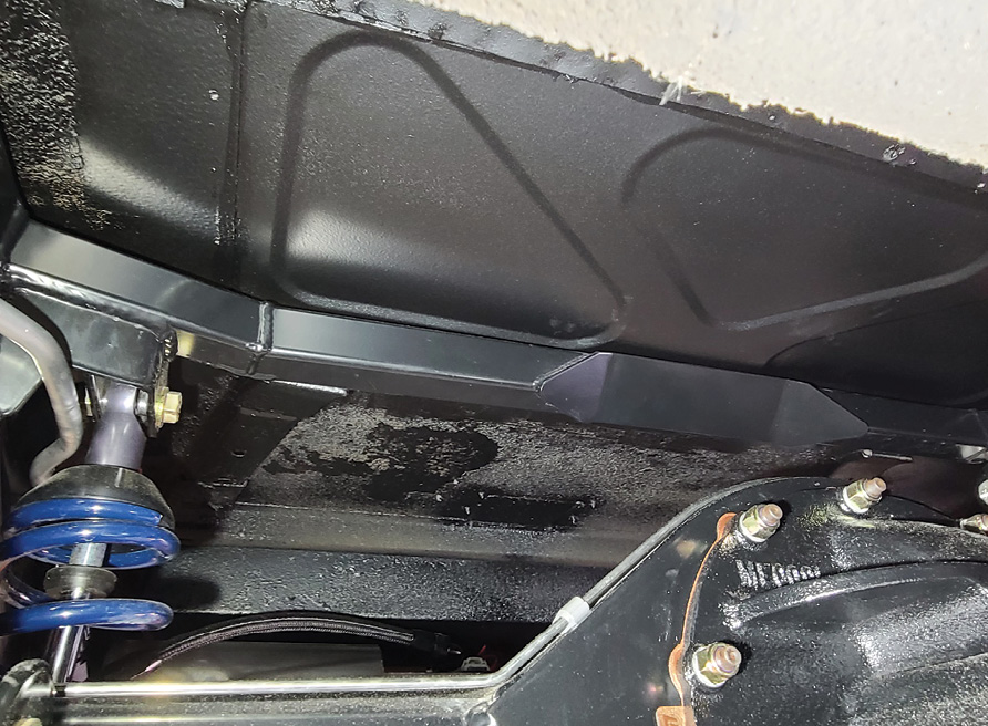 With the new floor piece welded in and covered with undercoating, the body can again be set in place (this time without any restrictions) and be bolted down for good.