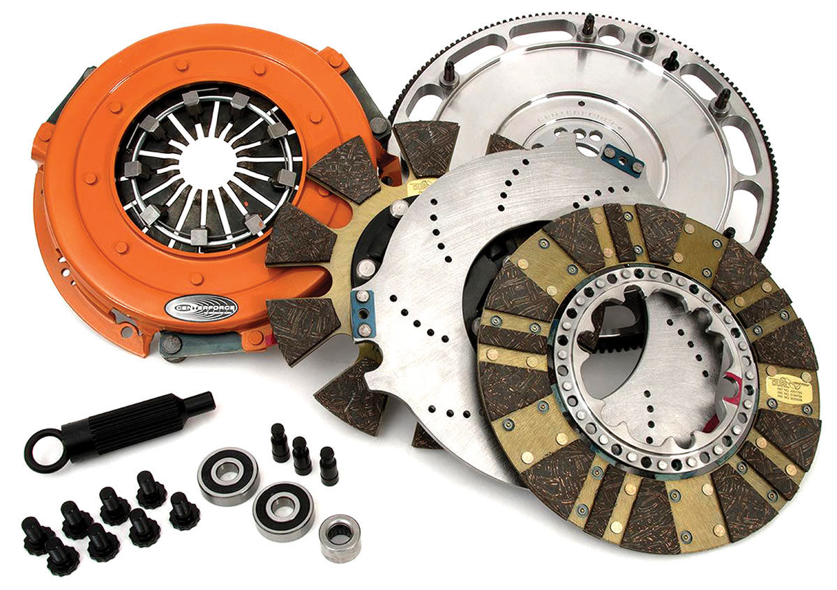 This is a Centerforce DYAD dual-disc assembly for an LS engine package. There are several details here worth mentioning. Note how the outer diameter of the flywheel is cut out to reduce inertia forces generated by the flywheel. Also, the difference in design of the two separate clutch discs. A notable aspect of the DYAD system is how the floater is mounted to reduce noise generated by the floater when pressure plate load is released.
