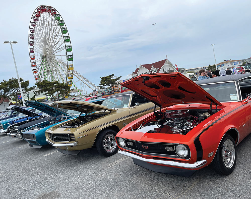 Row of 1st gen Camaros with open hoods