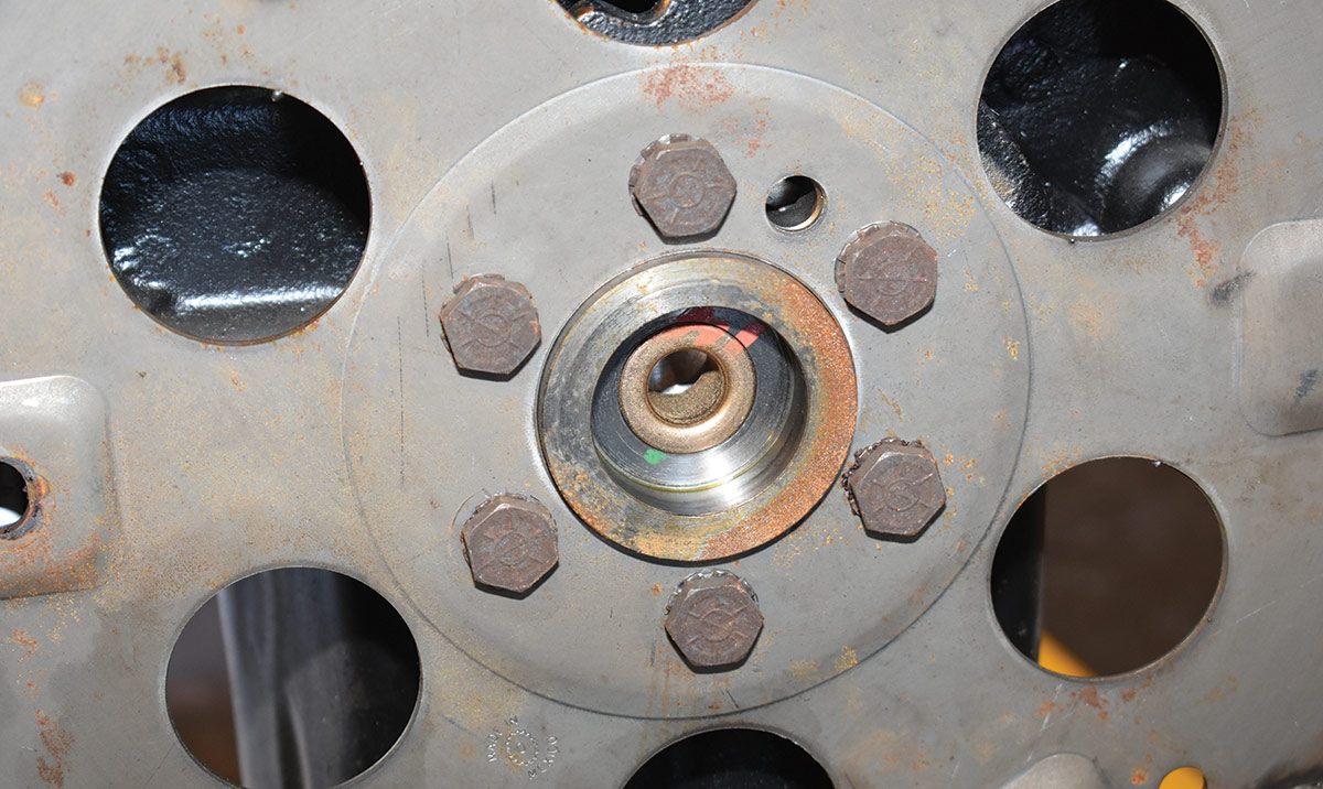 This crate engine came with a pilot bushing for a manual transmission, which in turn kept the converter from seating and warped the flexplate and caused the starter to make a ridiculous amount of noise.