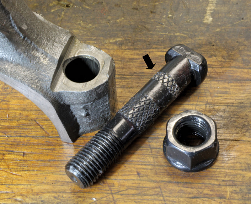 We removed a couple of the ARP rod bolts from the surviving connecting rods. Note how the upper serrations on this ARP bolt are deformed (arrow). If the inside diameter of the rod that failed was slightly smaller than the other rods, this could have prevented the bolt from fully seating in the rod.