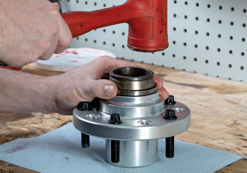 Load the inner wheel bearing in place and tap in the supplied hub seal. We used an old bearing race to drive in the seal straight and flush to the edge of the hub. Our hub also came with the wheel studs installed. It’s smart to ensure these are all torqued according to spec prior to use.<br />
