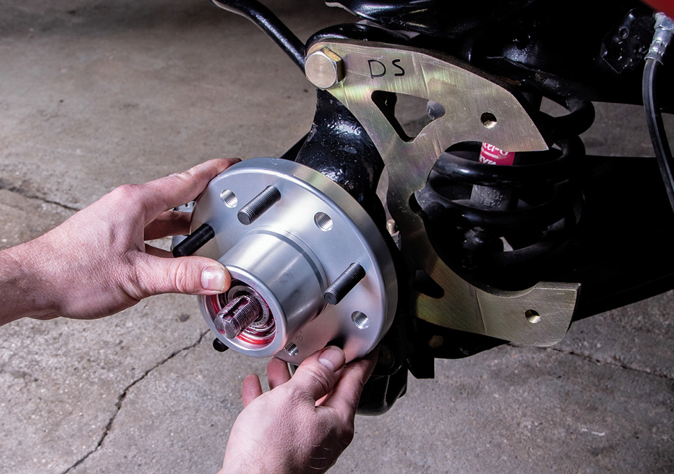 Apply a small amount of wheel bearing grease to the spindle stub before installing the hub and gently slide the hub into place.