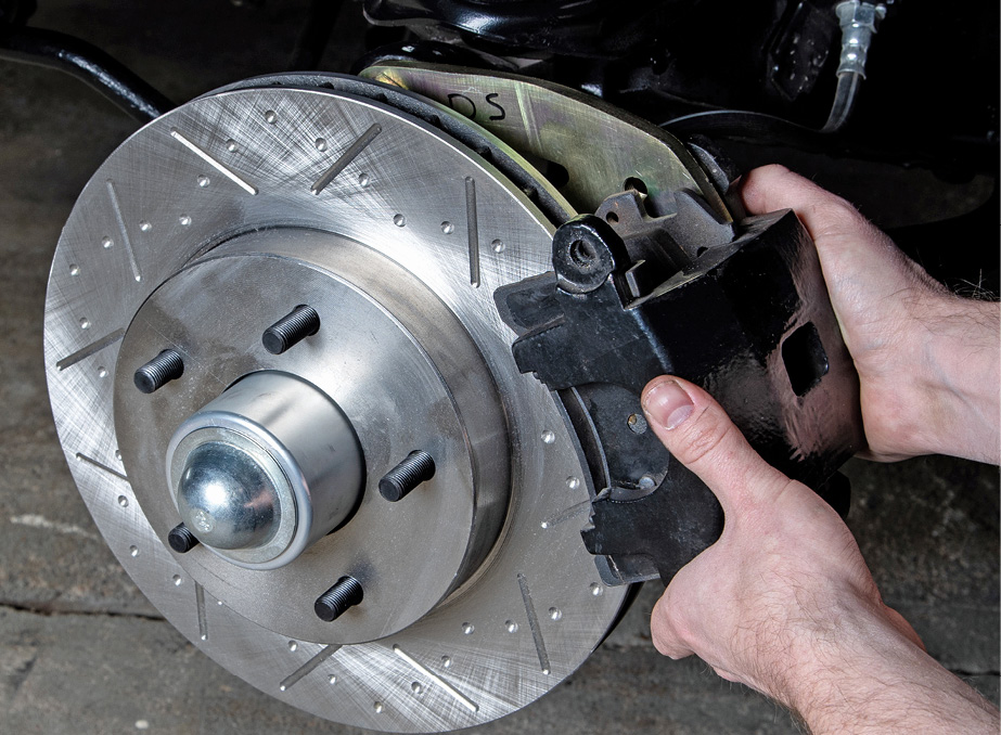 We bolted on the upper and lower caliper slide pins using a hex socket. Repeat the above steps to finish out the driver side assembly.