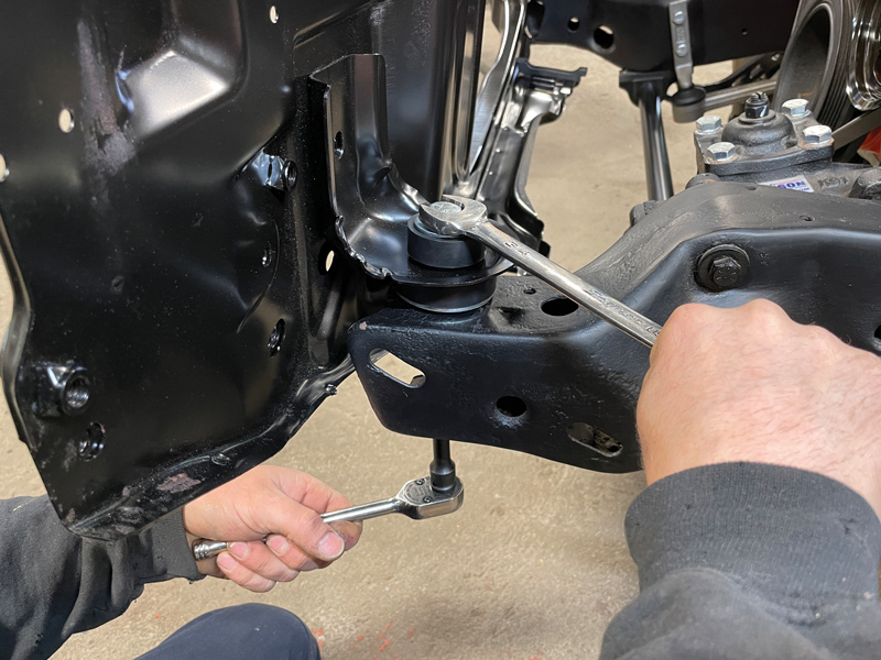 Using new factory replacement hardware provided in the kit, the core support was mounted in place using a 3/4-inch wrench and socket.