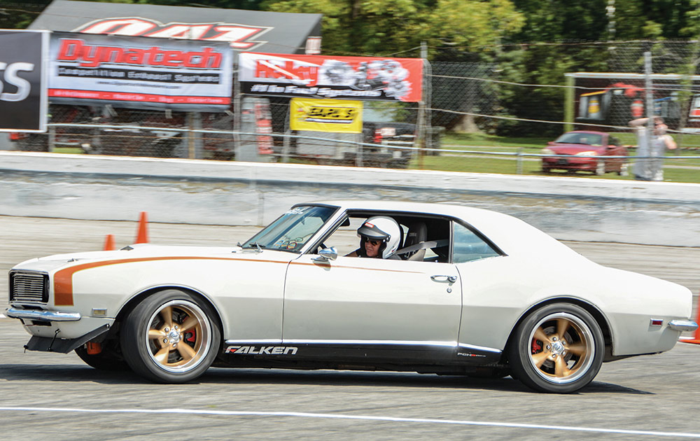 Silver '68 coupe on track with custom orange hockey stick style side stripes