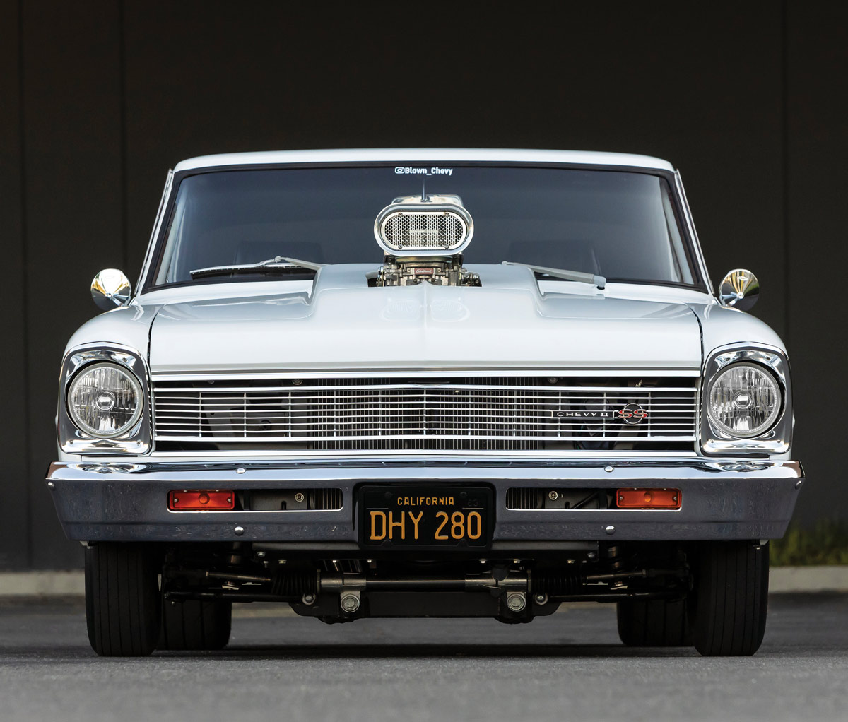 front of a white ’66 Chevy II Nova
