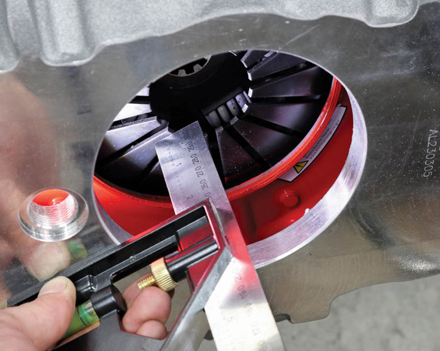 Our next measurement to verify was the air cushion of the concentric slave cylinder (CSC) or throwout bearing. To do this, we bolted the bellhousing back up to the engine. Using an adjustable square we measured the distance between the fingers of the clutch and the transmission mounting face on the bellhousing.