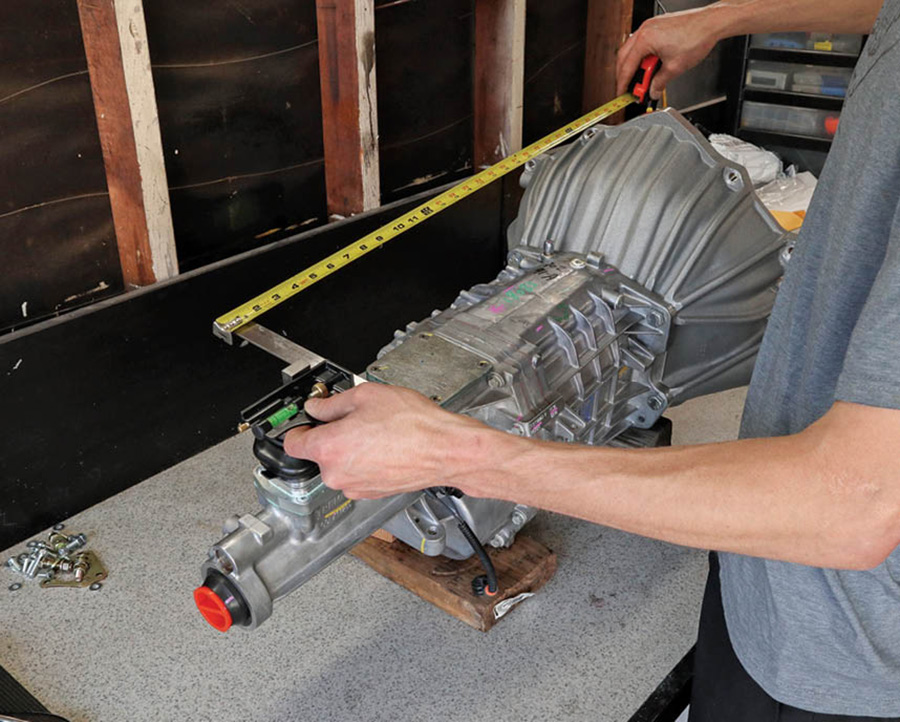 Next, it was time for the fun stuff: cutting up our factory automatic transmission tunnel. To get in the ballpark, we measured from the mounting face of the bellhousing back to the centerline of the shifter. Then, with the engine sitting on the motor mounts, we transferred those measurements to the underside of the trans tunnel.
