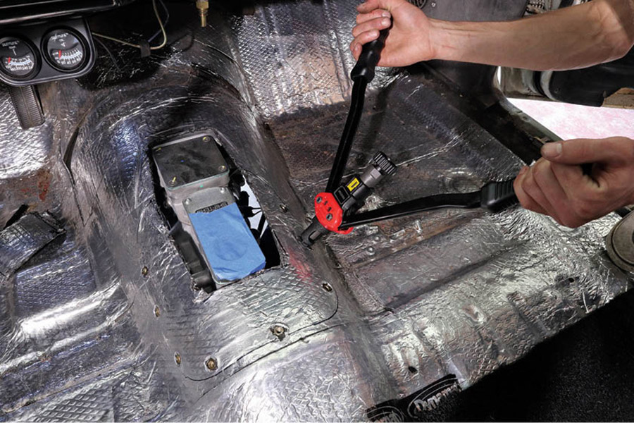 SST called for the use of a factory four-speed tunnel hump, so we decided we’d modify ours to cover the larger hole in the tunnel. Then, to make it removable, we picked up a rivet nut installation tool for $75 on Amazon and installed a few rivet nuts.