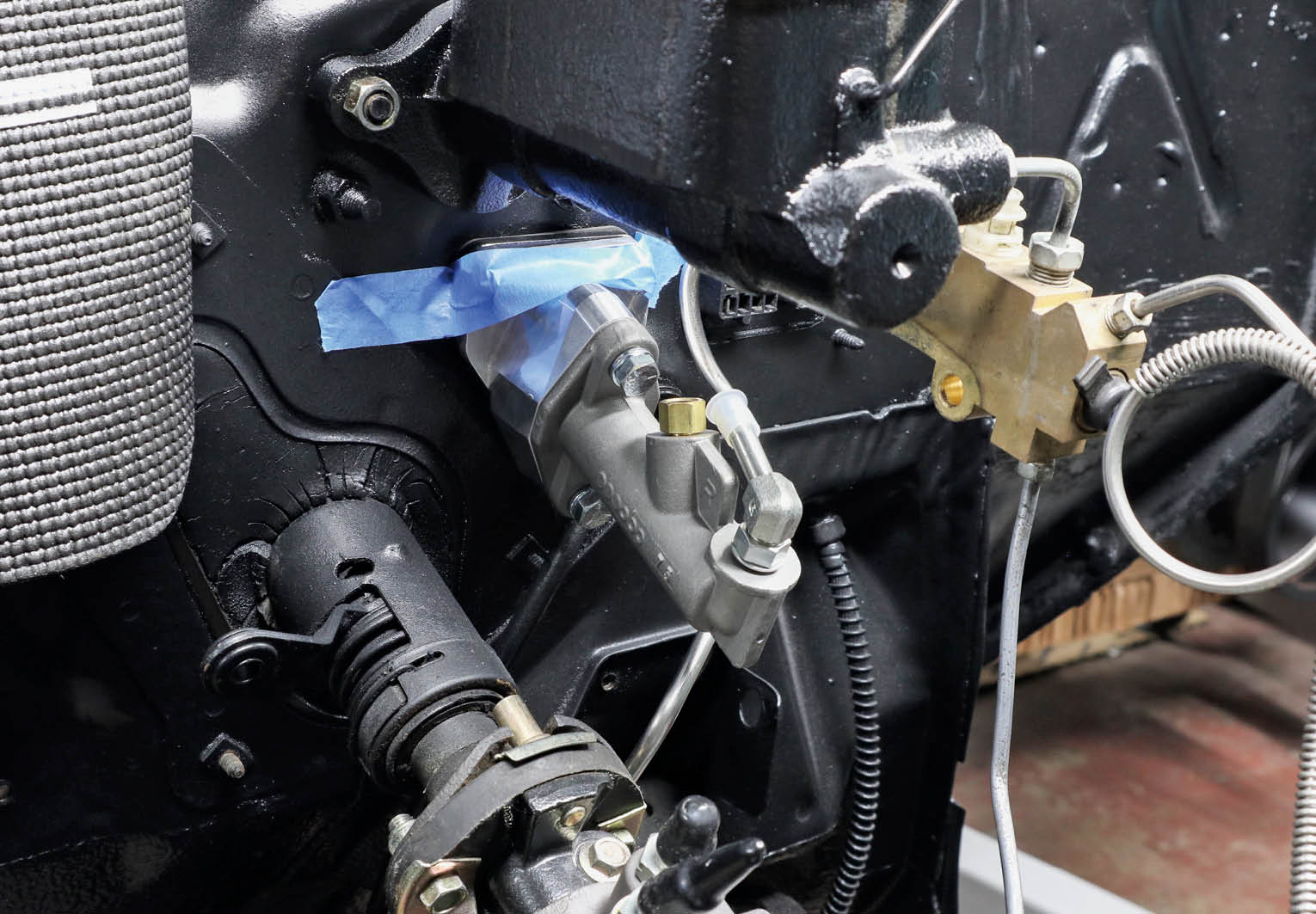 Getting the top two bolts and nuts started can be tough by yourself, so SST recommended using a piece of painter’s tape to hold the bolts in place while going under the dash to thread on the nuts.