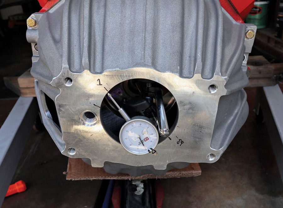 Next we measured the runout on our bellhousing. SST supplied great instructions on this, but we’ll describe it in short. Using a magnetic base and dial indicator we checked how centered the bellhousing is to the crankshaft. It takes some trial and error to get the orientation just right, but a great trick SST mentioned is removing a couple bolts on the flywheel to provide a flat mounting surface for the magnetic base. In our case, we were just outside the 0.005-inch maximum runout and needed to get a set of offset dowel pins to correct it.