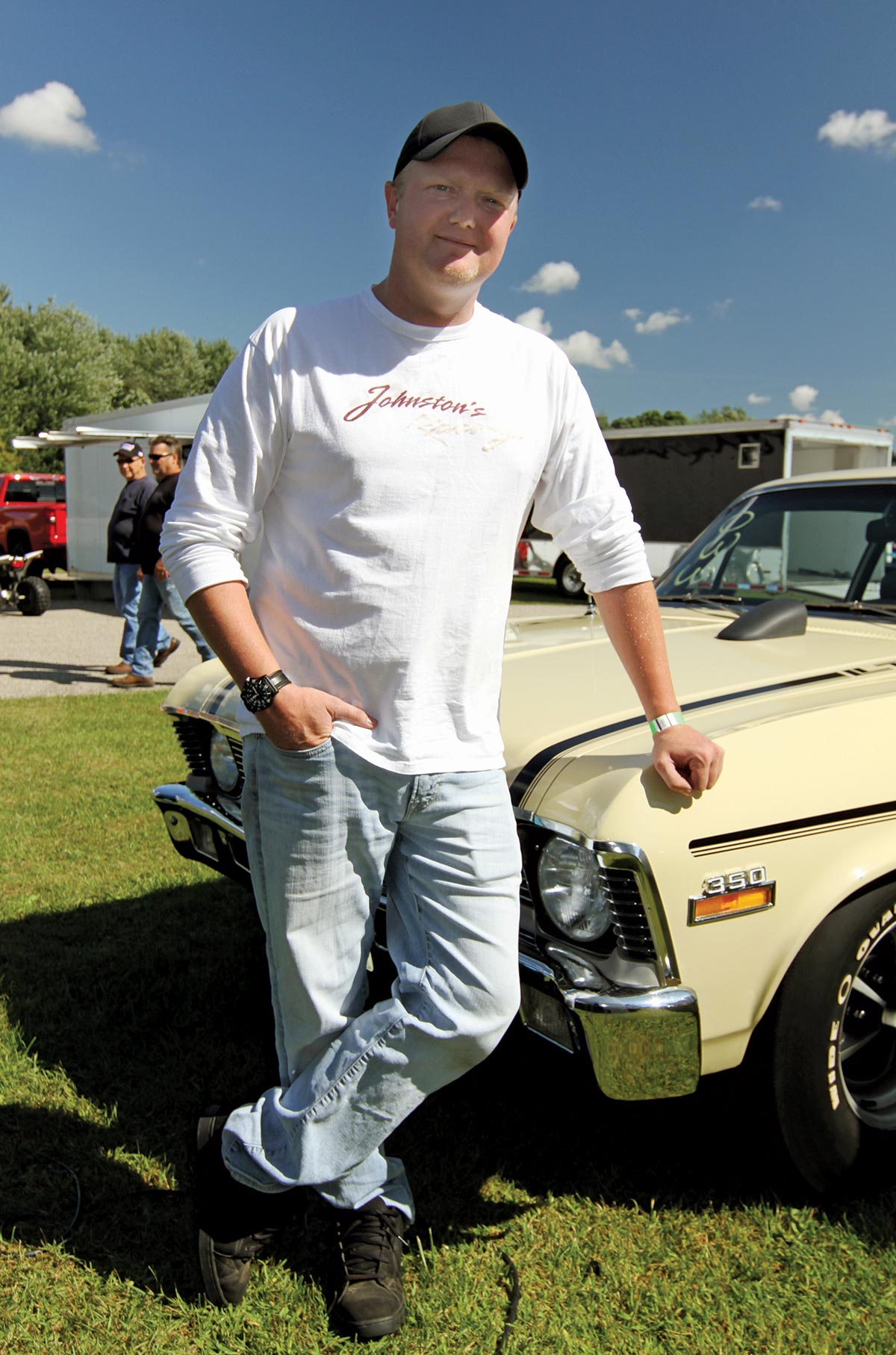 Canadian competitor Owen Simpson standing in front of a car