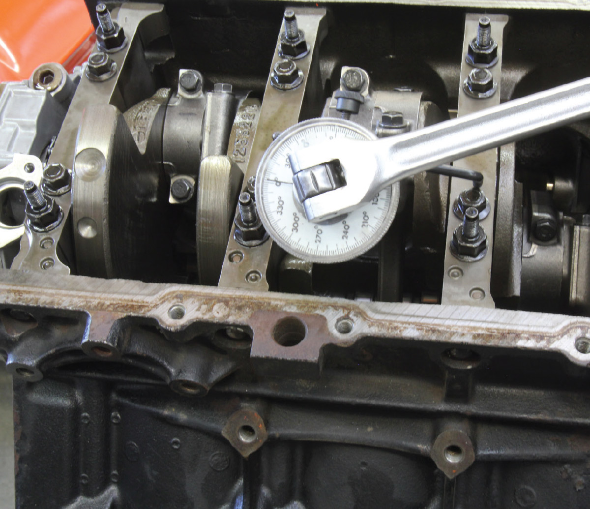 LS engines employ a torque angle spec for the mains, rods, head bolts, and other fasteners. This OTC tool is inexpensive and will do the job easily, but there is a learning curve to positioning the angled stop to ensure the gauge moves accurately. Torque angle is expressed first with a torque setting followed by a specific angle. A typical spec might be 22 lb-ft followed by tightening the fastener an additional 90 degrees.