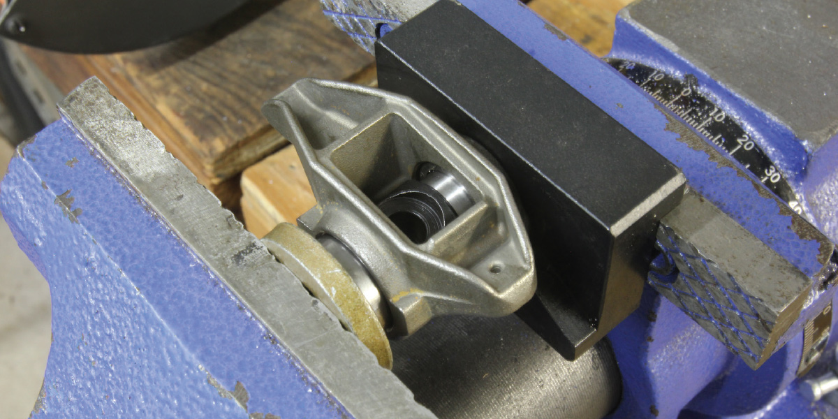 Summit makes a great tool for replacing the factory LS rocker arm trunion with a heavy-duty shaft and bearings. The best part is that the tool base employs a magnet to hold the fixture in place in the vise while removing the old bearings and inserting the new ones.