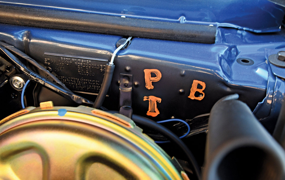 close view of the letters P-B-T on an engine bay wall on the dusk blue ’69 COPO Camaro