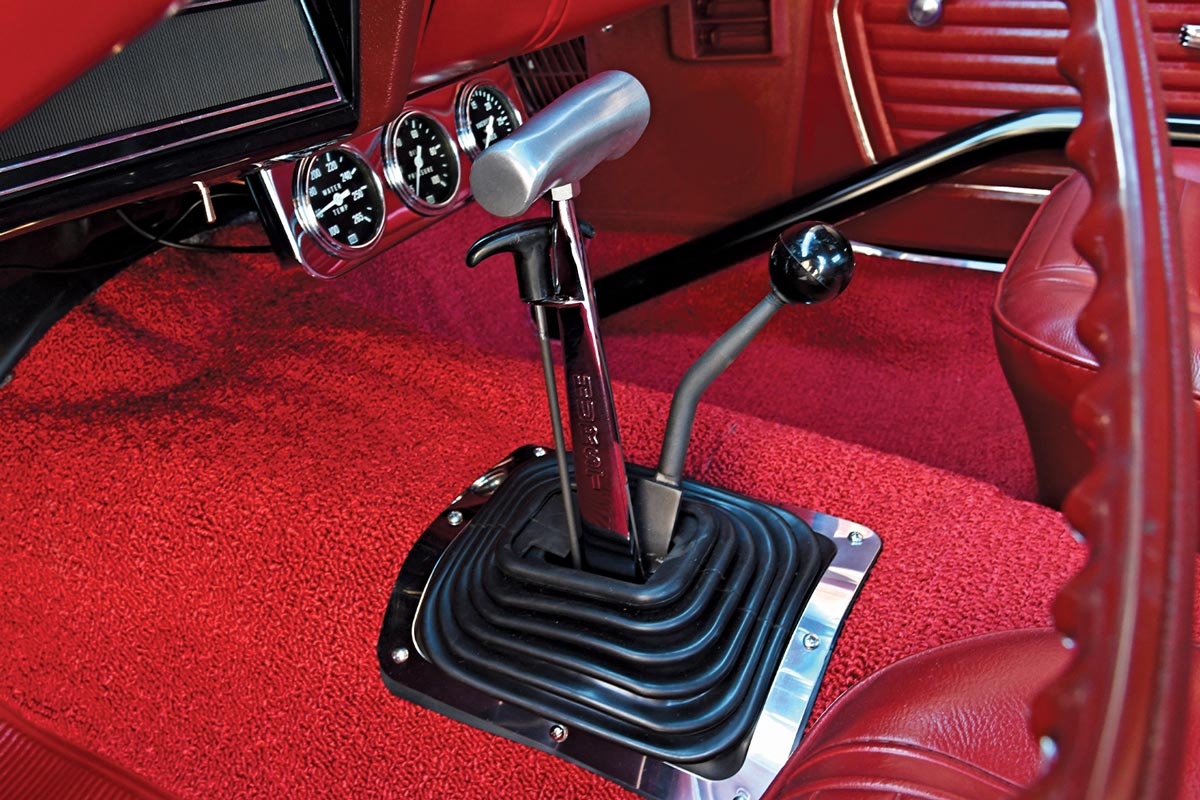 the ’69 Garnet Red COPO Camaro's below dashboard gauges and gear shifts and emergency brake