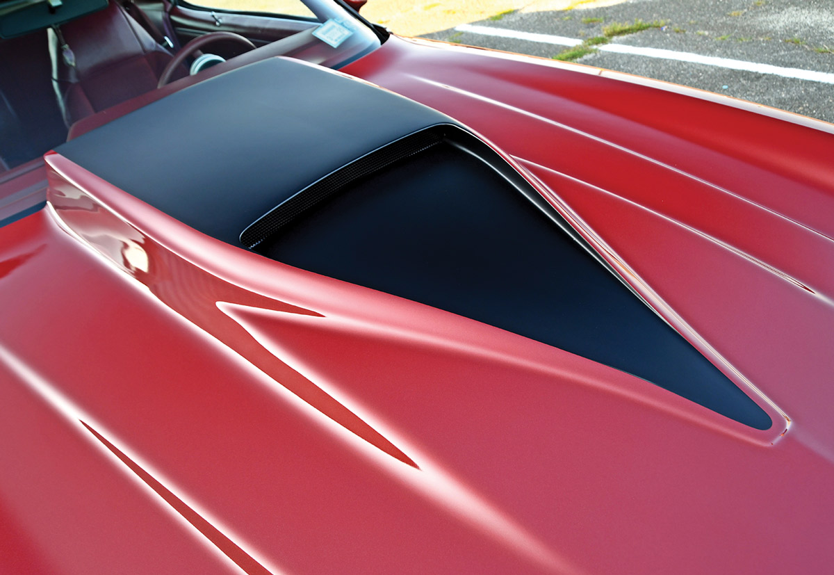 close view of the Flame Red ’79 Camaro Berlinetta's hood vent featuring a central black accent