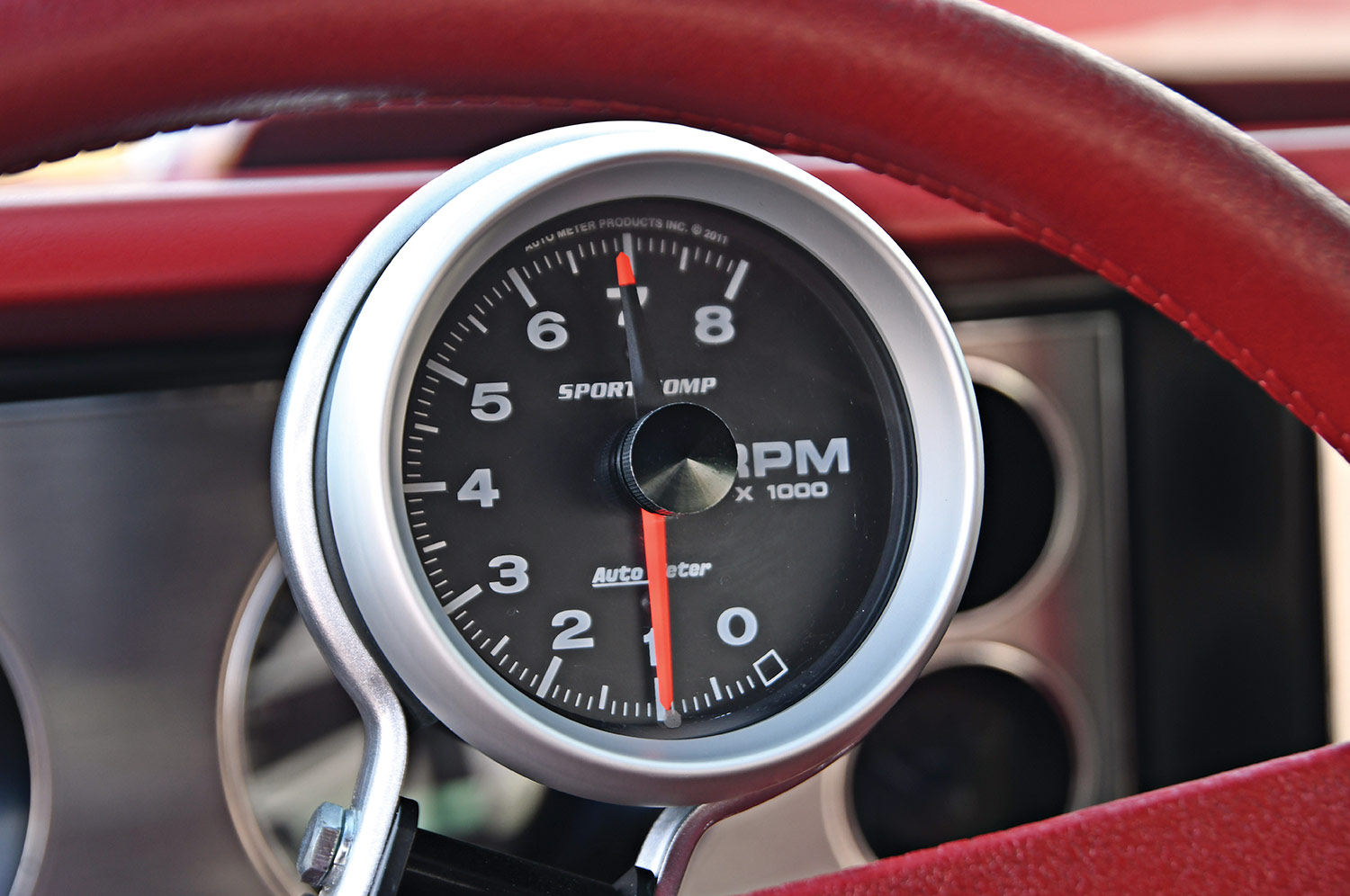 close up of the Flame Red ’79 Camaro Berlinetta's RPM gauge