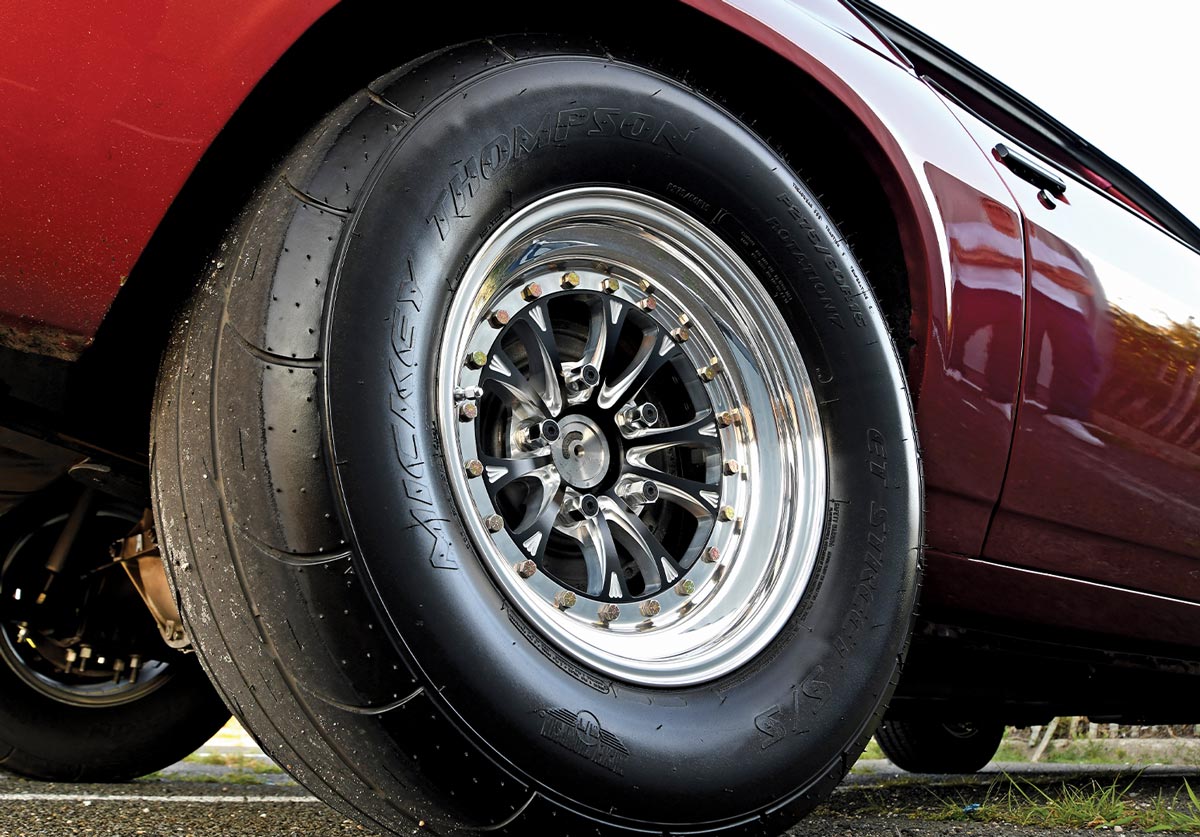 close view of a rear Mickey Thompson ET Street SS 275/60R15 tire on the Flame Red ’79 Camaro Berlinetta