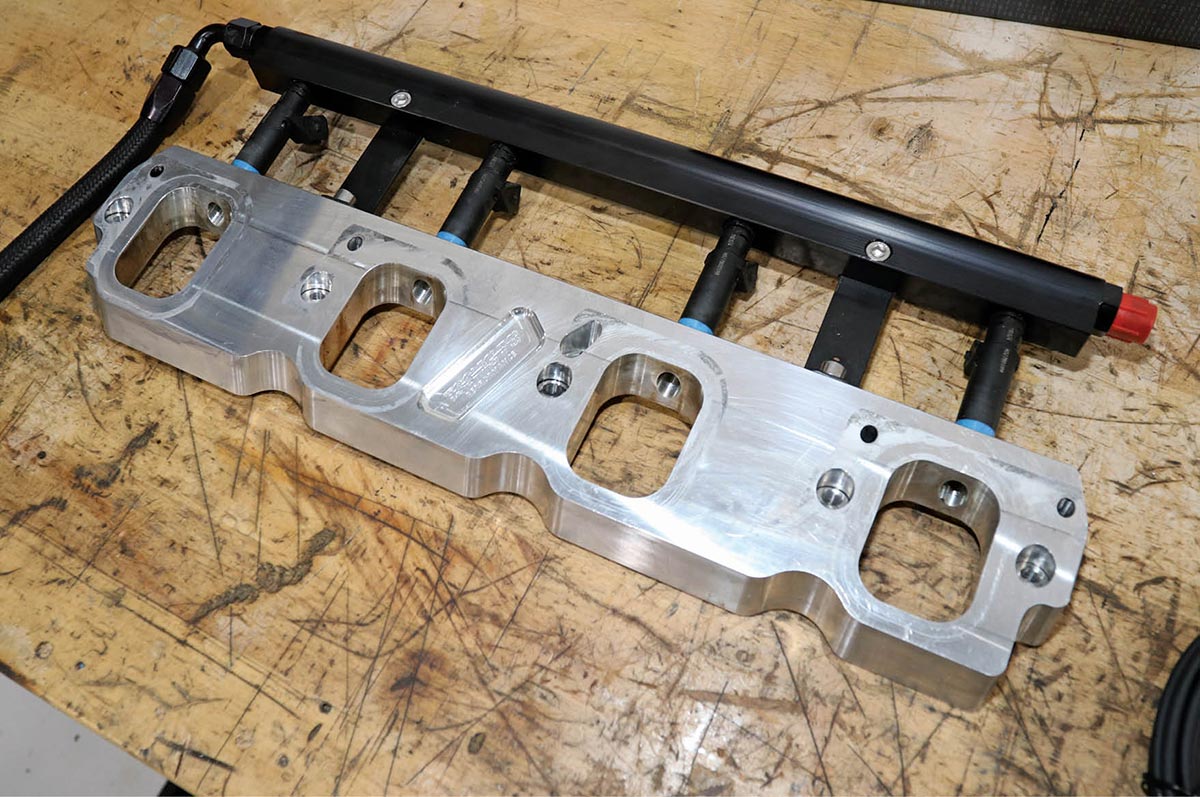 One of the easiest ways to add port fuel injection to an LT-series engine is a TooHighPsi Engineering Port Plate that sandwiches between the cylinder heads and intake manifold and locates the new injectors ideally. These are very popular when adding Magnuson superchargers.