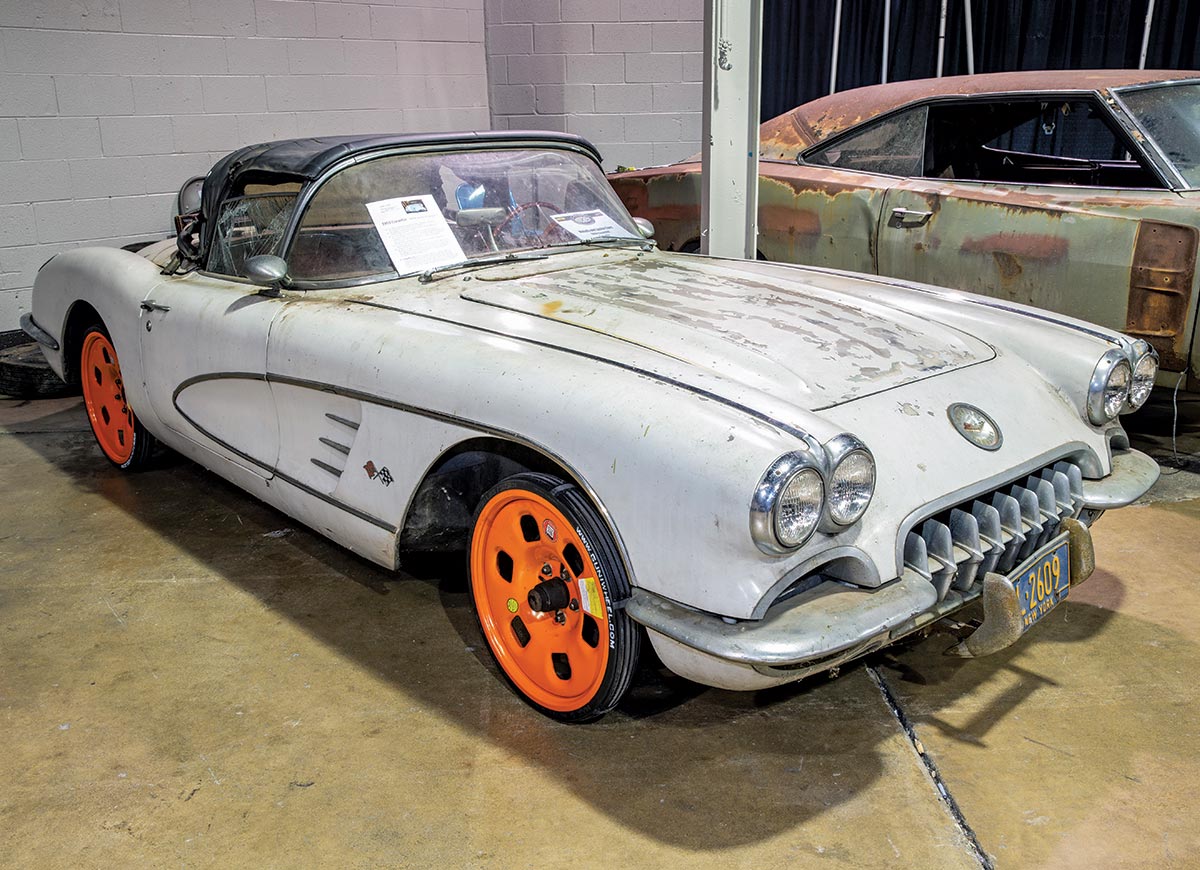 Close-up photograph perspective of a vintage rusty grey ’59 Corvette car in a display area of a showroom floor