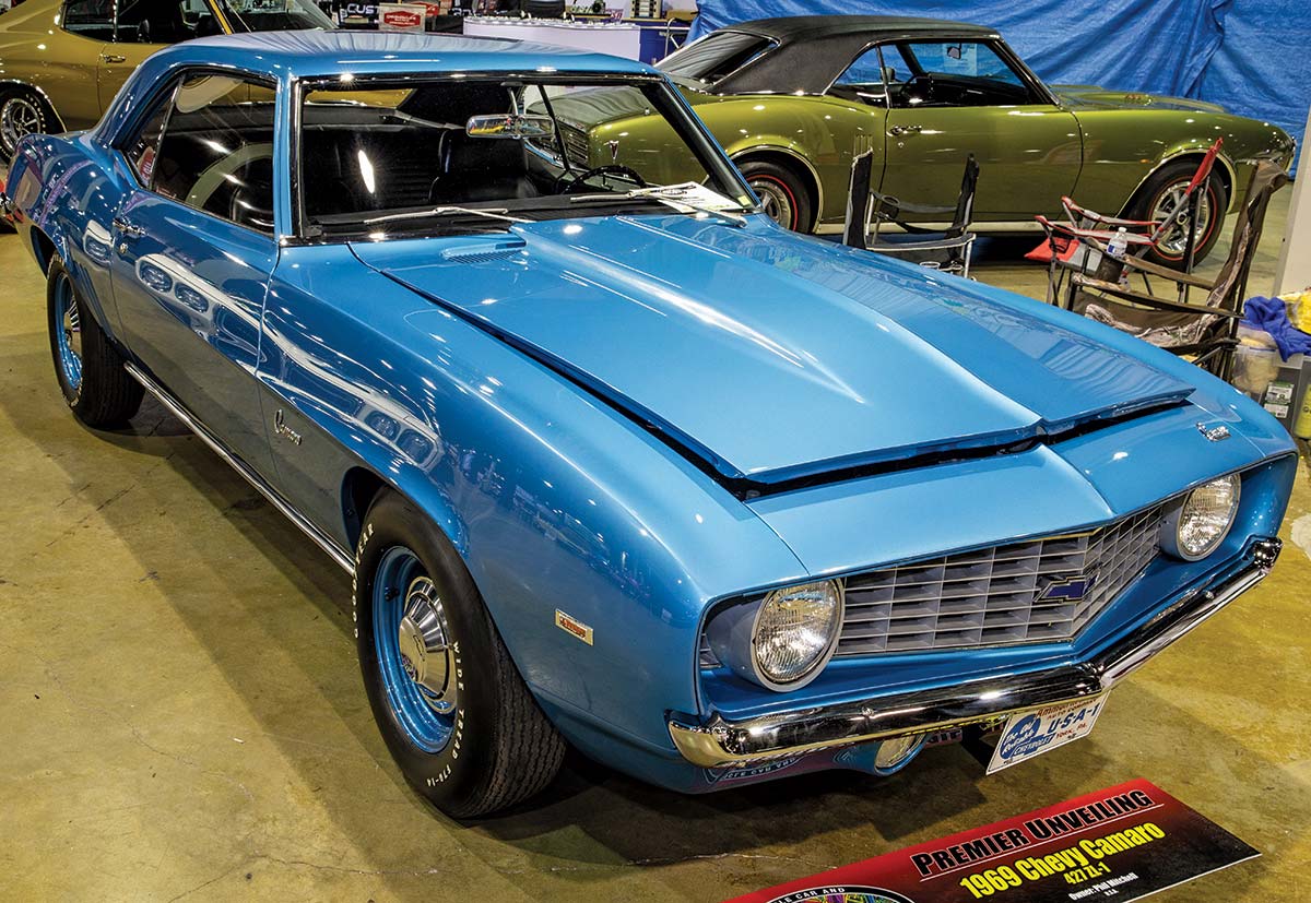 Close-up photograph perspective of a blue vintage ultrarare ’69 Camaro ZL1 car in a display area of a showroom floor