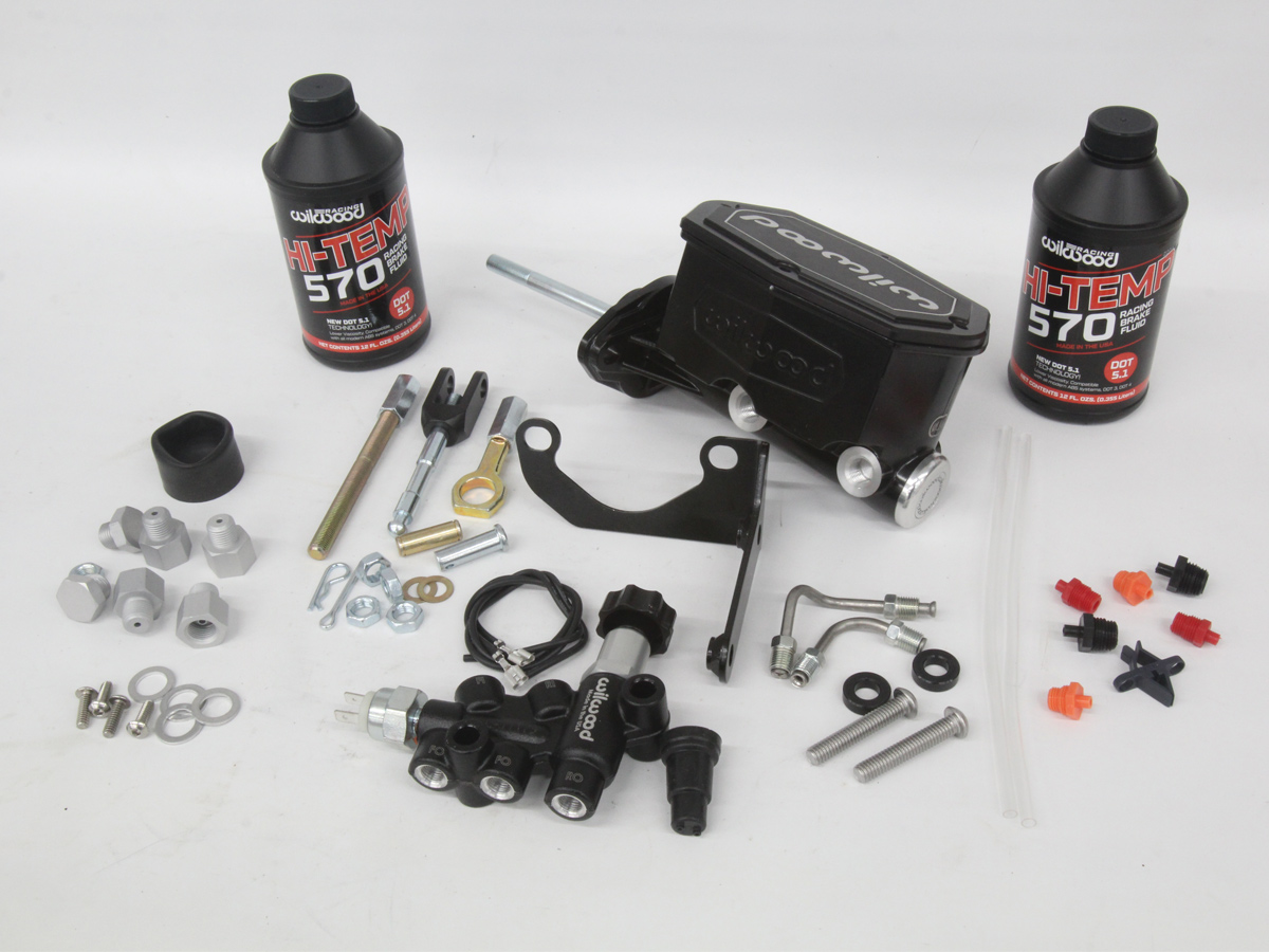 Pieces to a brake pedal adjustment kit laying on a table