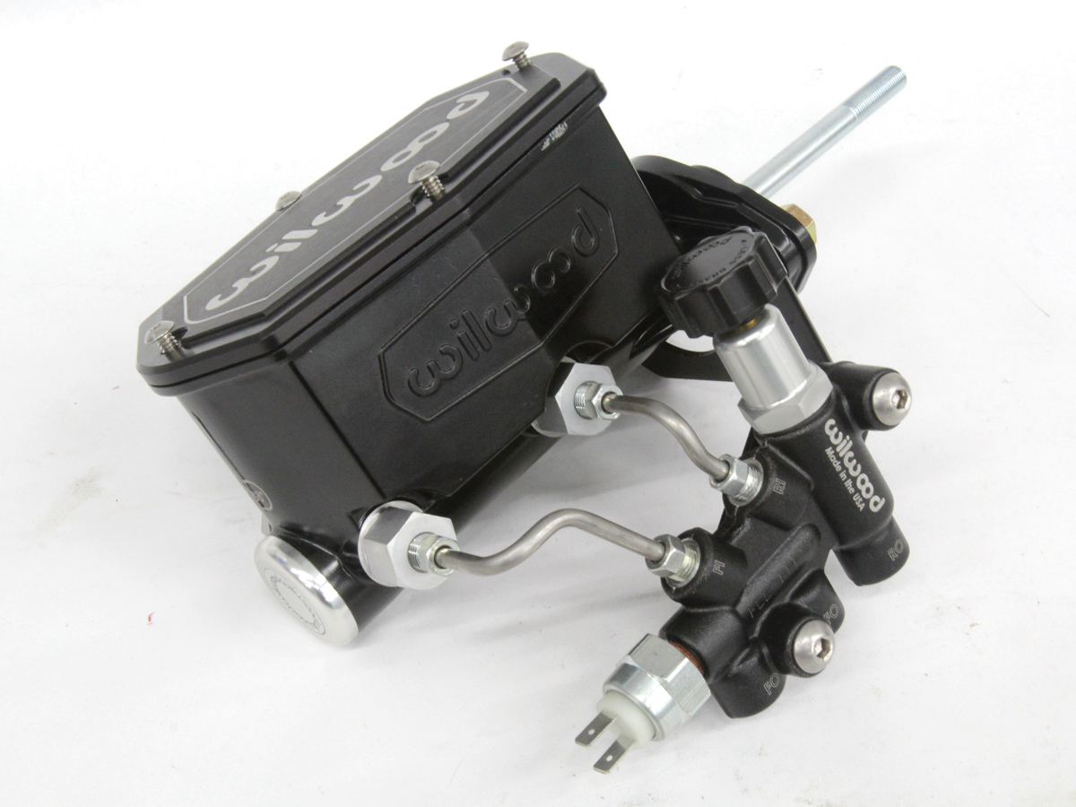 Assembled proportioning valve bracket and valve to the master laying on a table
