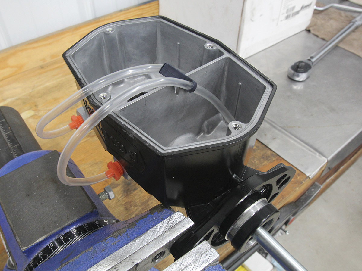 Above view of plastic tubes attached to the master cylinder sitting on a table