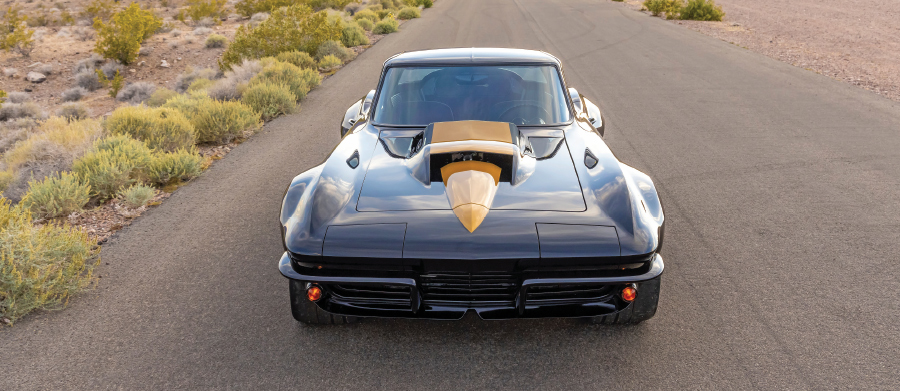black '67 corvette with yellow accents on a desert road