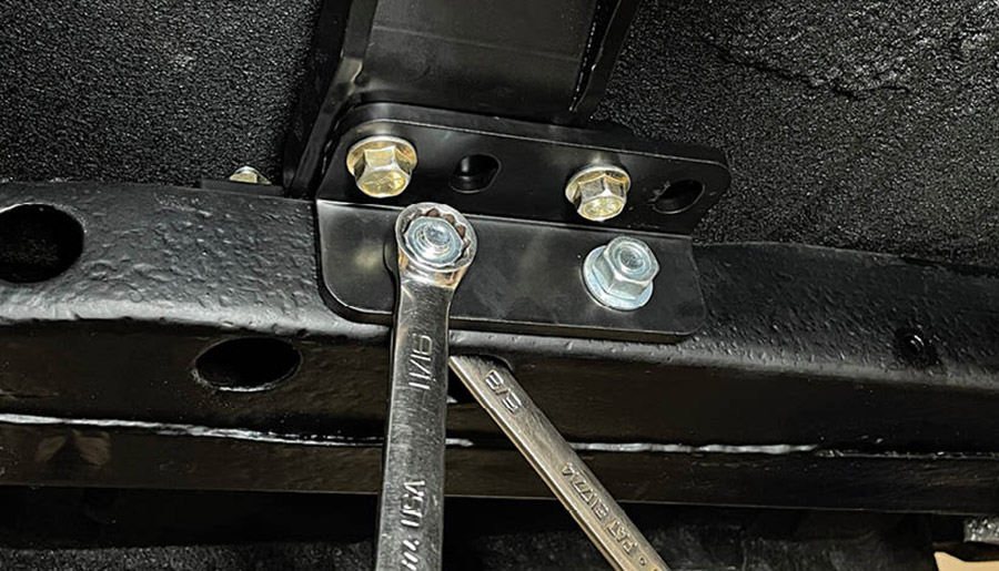 Reinstall brackets to the crossmember and follow with the included 7/16-inch bolts, flat washers, lock washers, and nuts. Install the bolts and lock washers from inside the subframe, note that this step can take some time to complete.