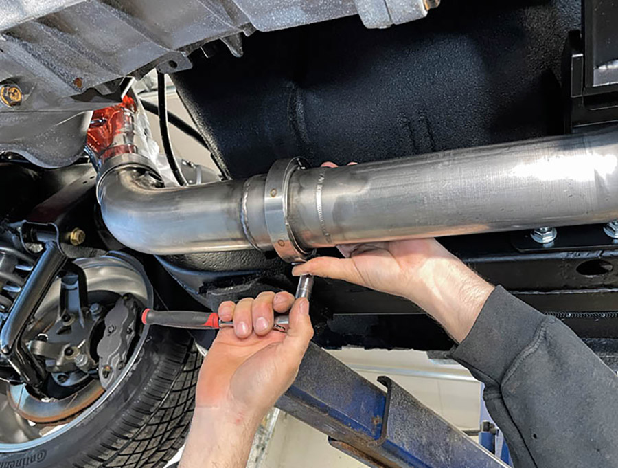 Using an auxiliary stand to support the exhaust, the mid-pipes were fastened to the header mid-pipes using a V-band clamp on each side.