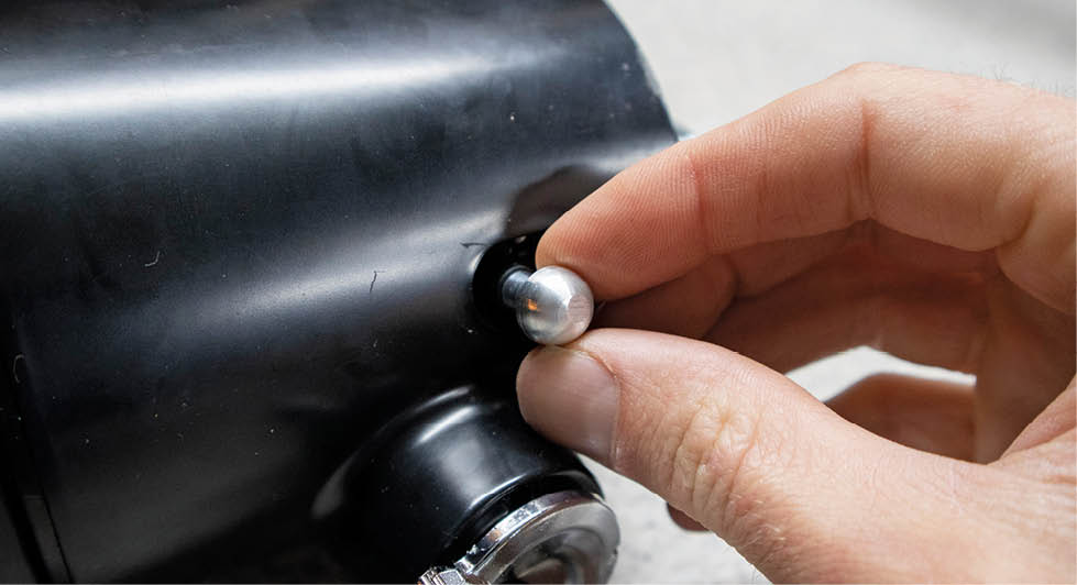 A small setscrew is spun into place and used as a stud for the hazard knob to screw onto.